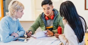 Teens Around a table talking financial literacy